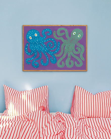 interior image of the poster hanging on a blue wall in a bedroom