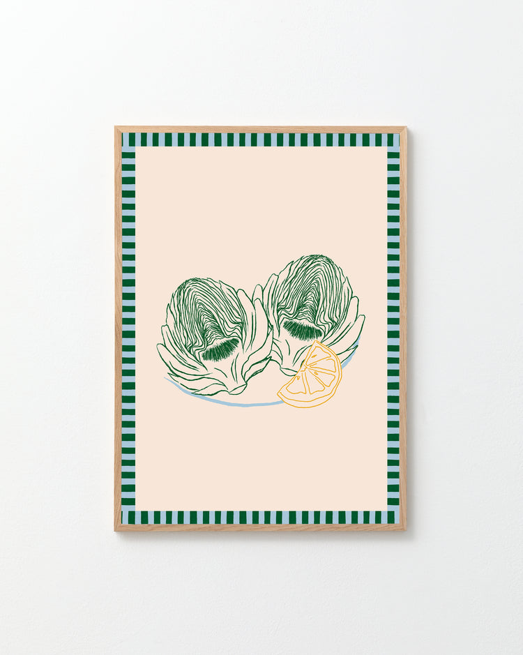 The Les Artichauts Poster has framed artwork inspired by a French market, showcasing two green artichokes and a lemon slice on beige, with stylish green and black striped borders, ideal for home decor.