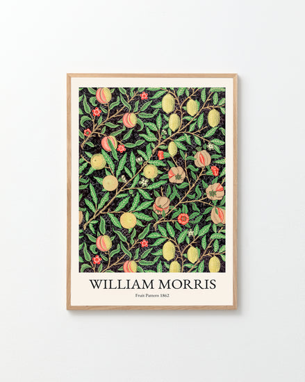 The white wall is beautifully decorated with a Fruit Pattern by William Morris Poster, featuring colorful fruits and leaves on a bold black background.