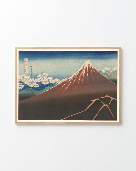 The Fuji above the Lightning by Katsushika Hokusai Poster showcases a snow-capped Mount Fuji under a blue sky with clouds, inspired by iconic Japanese art. The artwork uses serene blue, earthy brown, and crisp white tones.