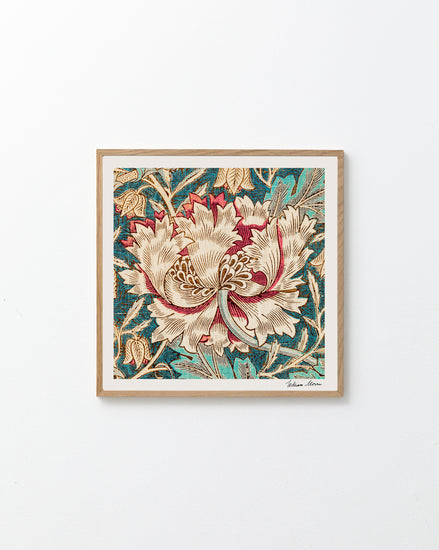 The light wood-framed Honeysuckle by William Morris Poster displays a central cream and red flower with lush green leaves on a textured blue background, capturing the Arts and Crafts eras spirit against a plain white wall.
