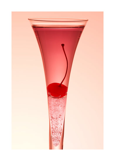 An eye-catching still life photograph showcasing a close-up of a drink adorned with a delectable cherry against a vibrant pink background. White border.