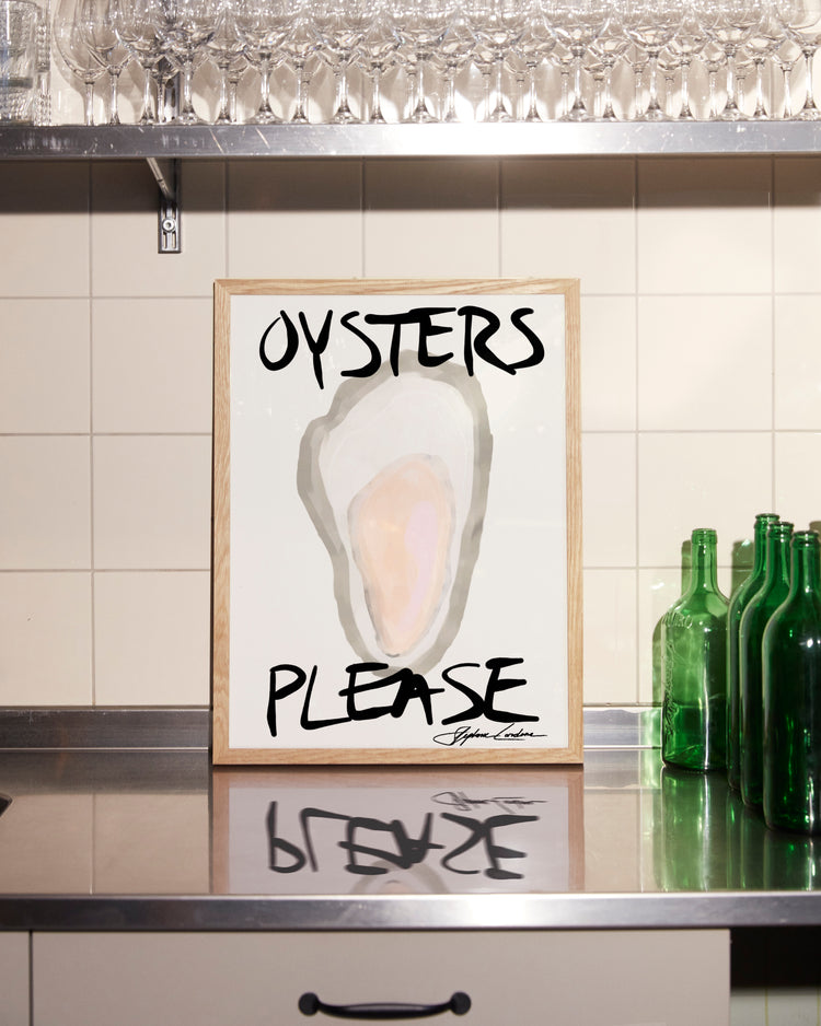 The framed Oysters Please Poster features a minimalistic digital design with bold black text, elegantly displayed on a stainless steel countertop against a tiled backsplash, surrounded by green bottles and glassware—ideal for seafood decor enthusiasts.