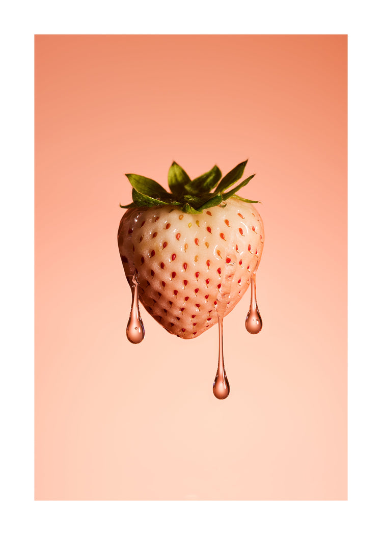 A stilllife photograph of a flawless white strawberry on a pretty pink background. White border.