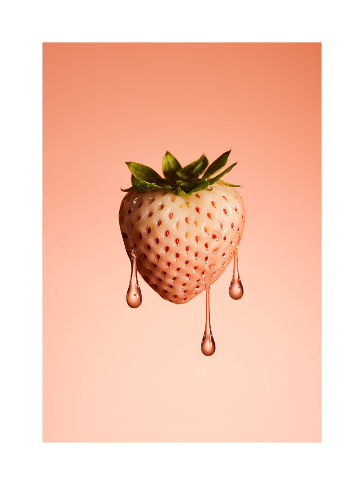 A stilllife photograph of a flawless white strawberry on a pretty pink background. White border.