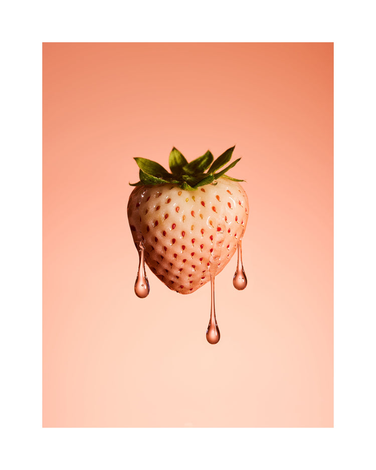 A stilllife photograph of a flawless white strawberry on a pretty pink background. White border.