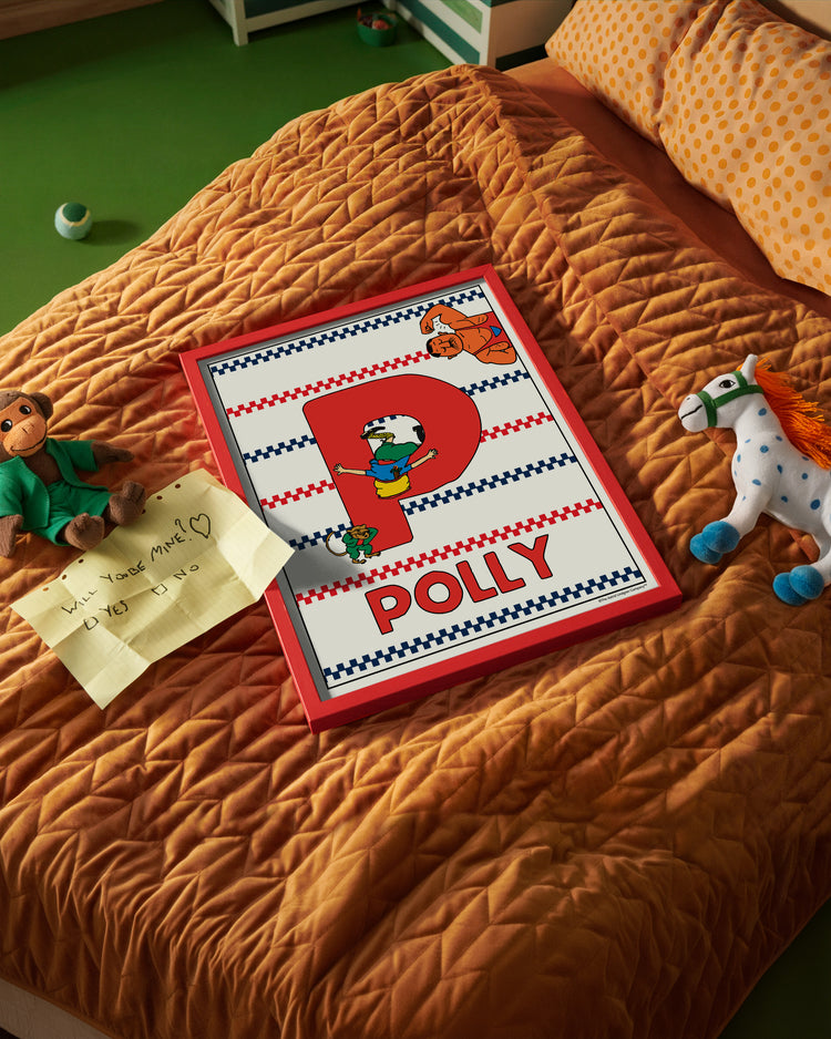 Pippi Longstocking name poster with the letter P and the name Polly, placed on a neatly made bed in a bright kids’ room.
