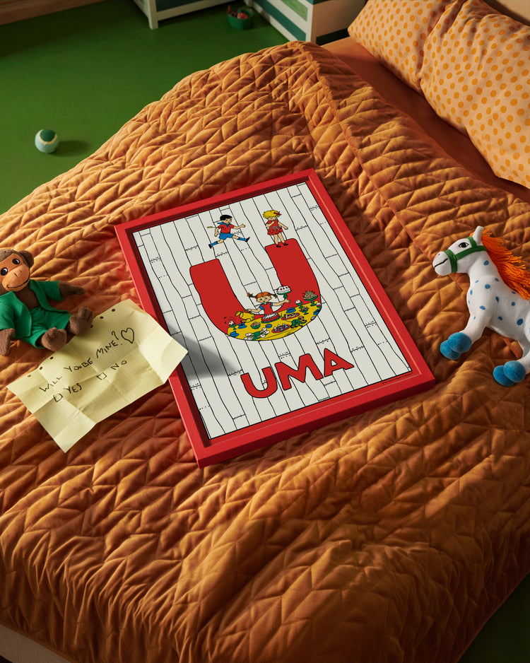 Pippi Longstocking name poster with the letter U and the name Uma, placed on a neatly made bed in a bright kids’ room.