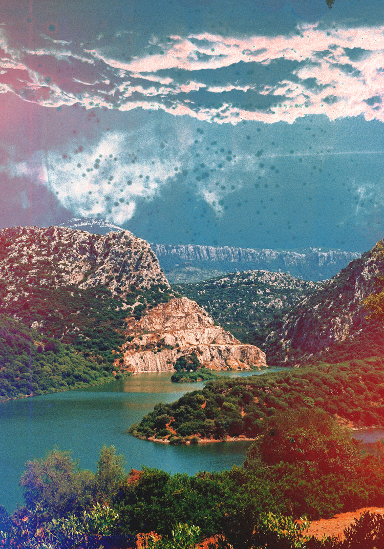 Canyon scenery with mountains covered in lush green forest and a blue river.