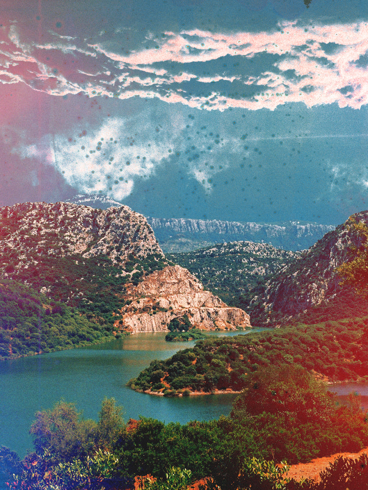 Canyon scenery with mountains covered in lush green forest and a blue river.