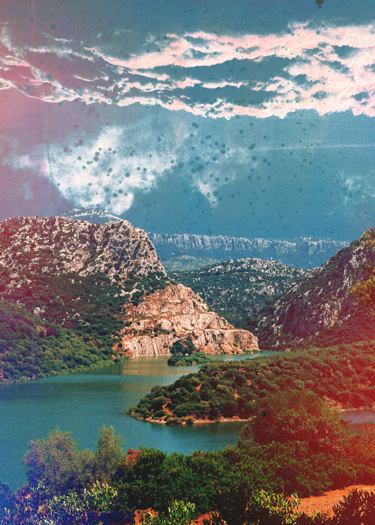 Canyon scenery with mountains covered in lush green forest and a blue river.