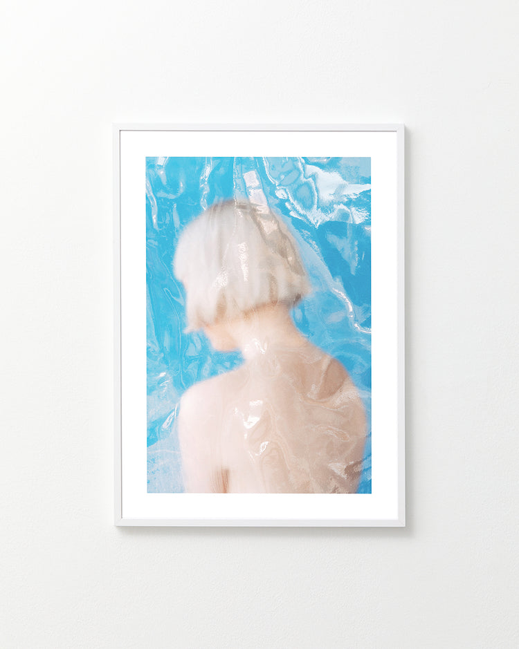 Short haired pale woman looking like a bust made from marble.