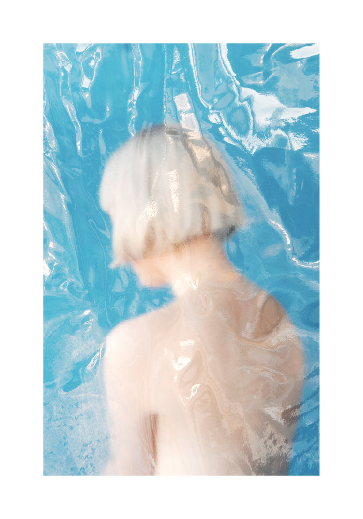 Short haired pale woman looking like a bust made from marble.
