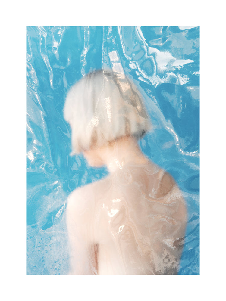Short haired pale woman looking like a bust made from marble.