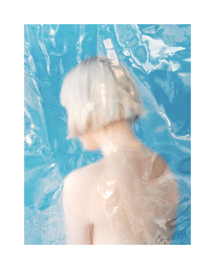 Short haired pale woman looking like a bust made from marble.