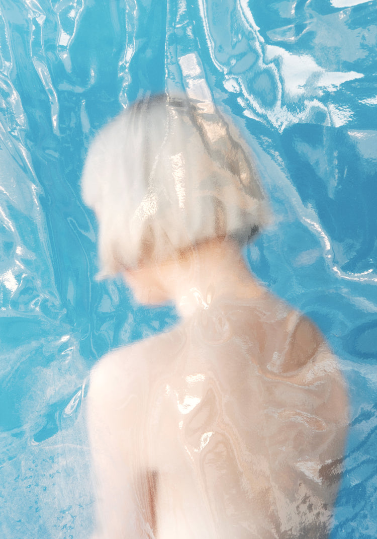 Short haired pale woman looking like a bust made from marble.