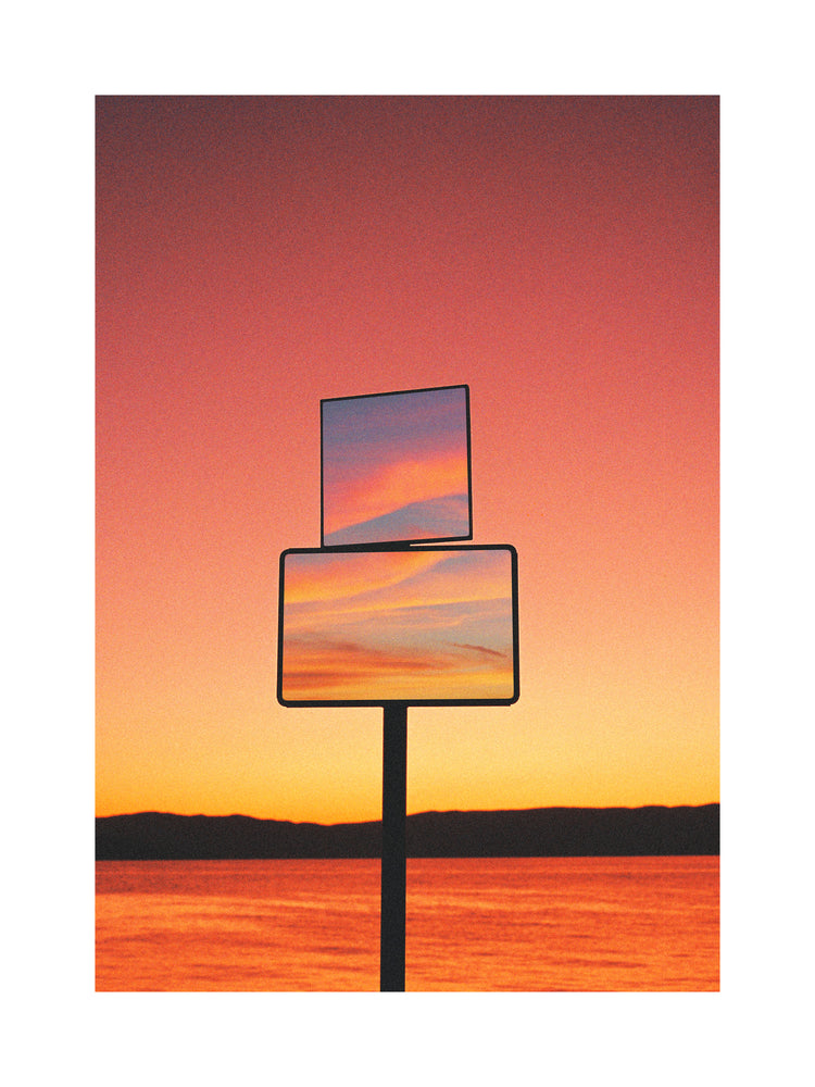 Mirrors reflecting a sunset scenery with sea and sky colored in orange and pink.