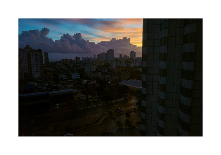 The Cuban capital Havana viewed from above under a sunset sky.