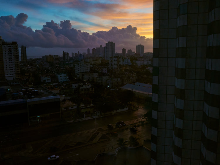 The Cuban capital Havana viewed from above under a sunset sky.