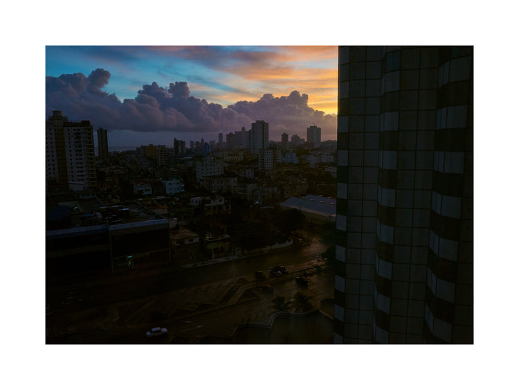The Cuban capital Havana viewed from above under a sunset sky.