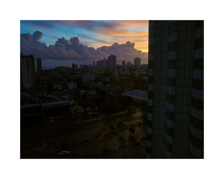 The Cuban capital Havana viewed from above under a sunset sky.