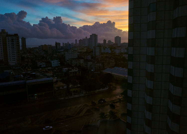 The Cuban capital Havana viewed from above under a sunset sky.