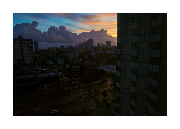 The Cuban capital Havana viewed from above under a sunset sky.