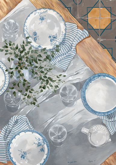 A top view shows The Good Plates Poster featuring dining details: blue and white patterned plates, clear glasses, a pitcher on a gray tablecloth, striped napkins beside each setting, a green leafy plant centerpiece, and partially visible geometric floor tiles.