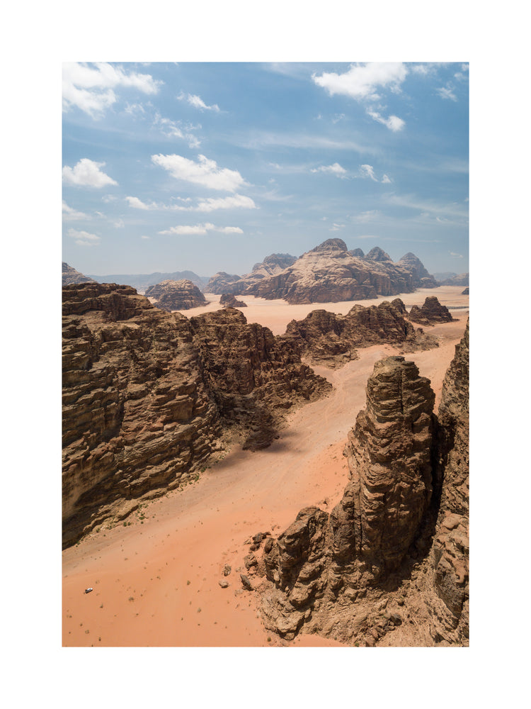 Landscape photograph with brown cliffs and rusty red dirt roads.