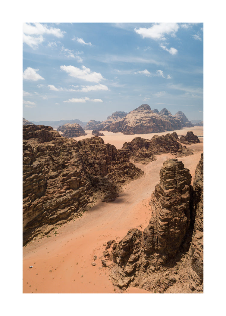 Landscape photograph with brown cliffs and rusty red dirt roads.