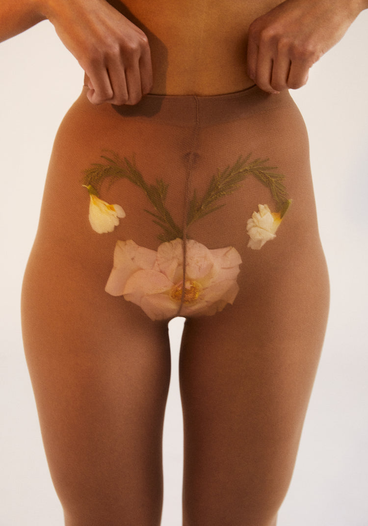 A woman in transparent stockings with a flower symbolizing her uterus.