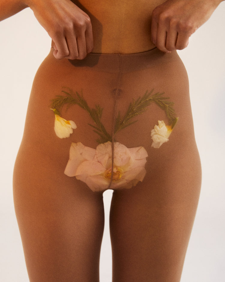 A woman in transparent stockings with a flower symbolizing her uterus.