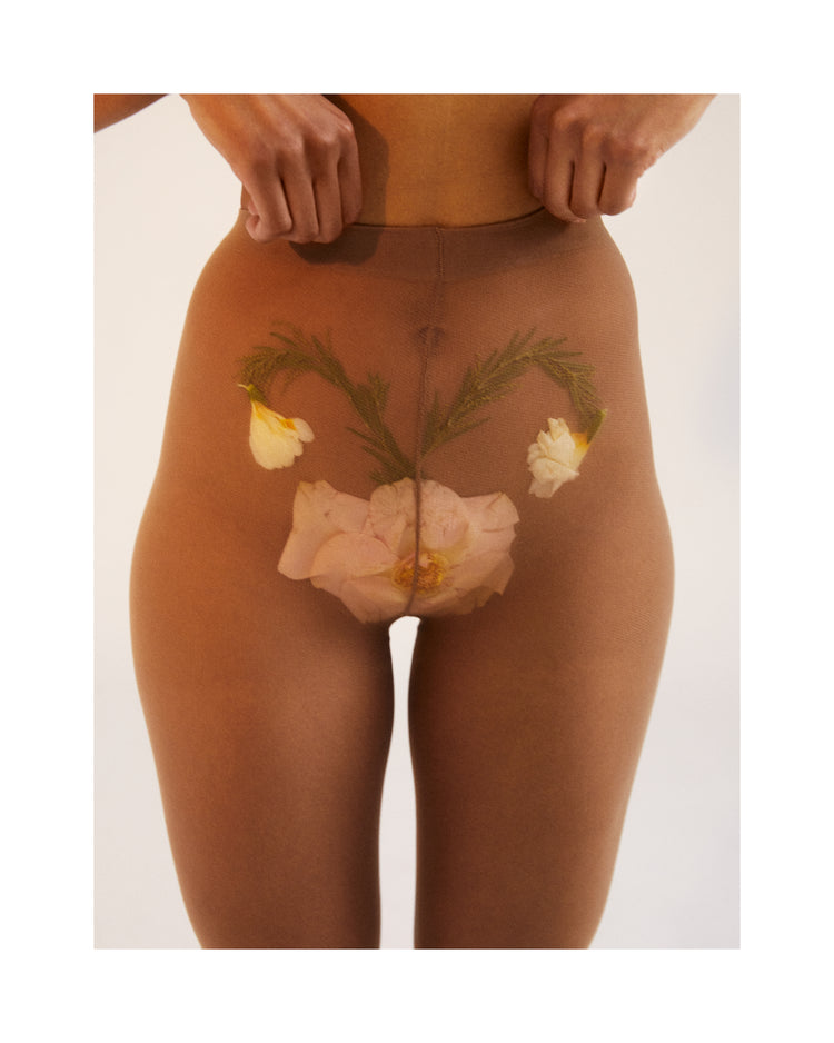 A woman in transparent stockings with a flower symbolizing her uterus.