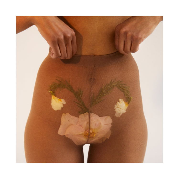 A woman in transparent stockings with a flower symbolizing her uterus.