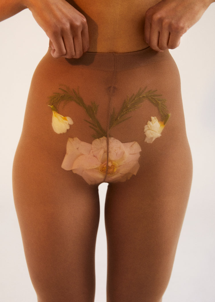 A woman in transparent stockings with a flower symbolizing her uterus.