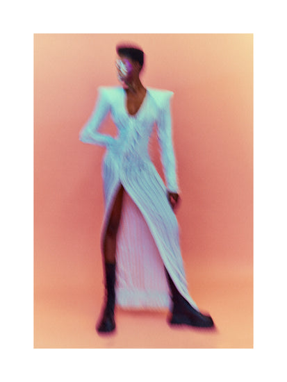 A blurry poster of a woman in a white dress in front of a peach pink background.
