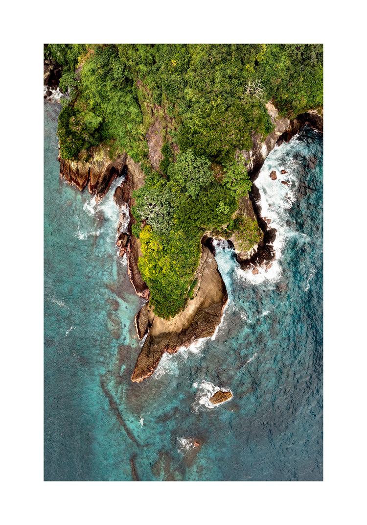 Paradise island covered in tropical jungle and surrounded by turquoise water.