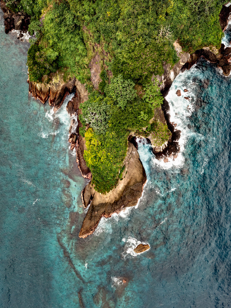 Paradise island covered in tropical jungle and surrounded by turquoise water.