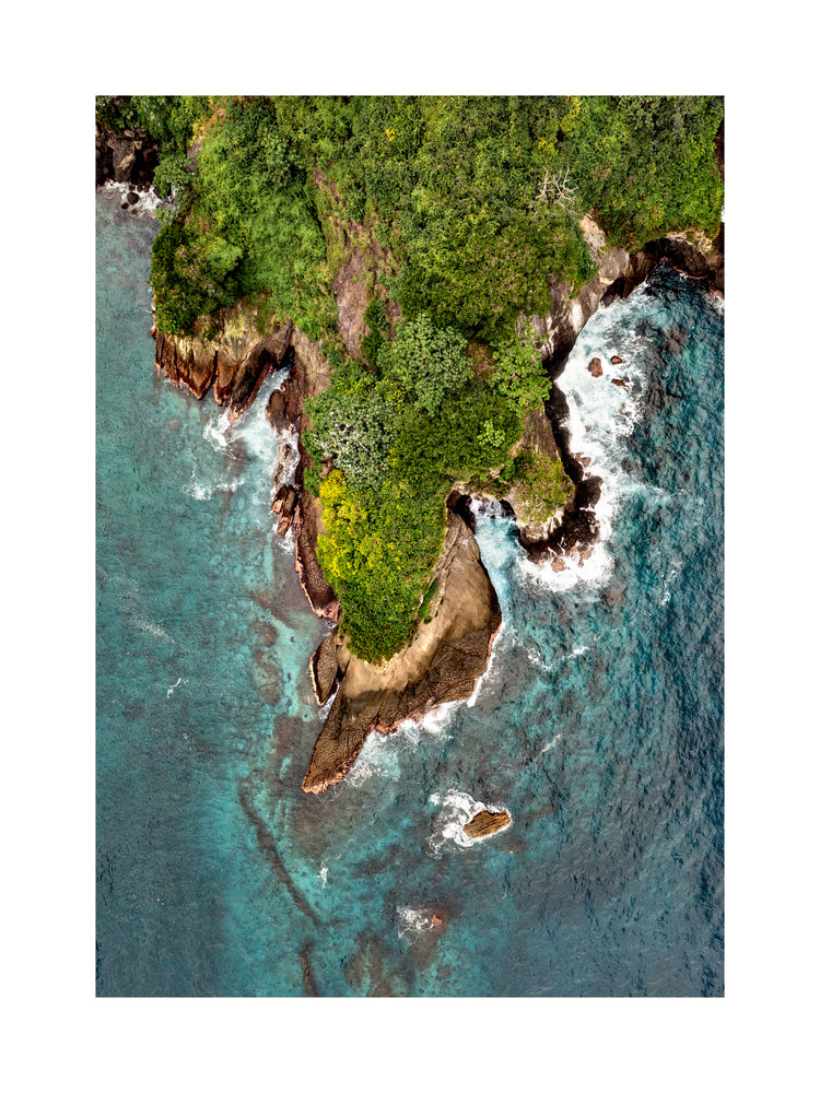 Paradise island covered in tropical jungle and surrounded by turquoise water.