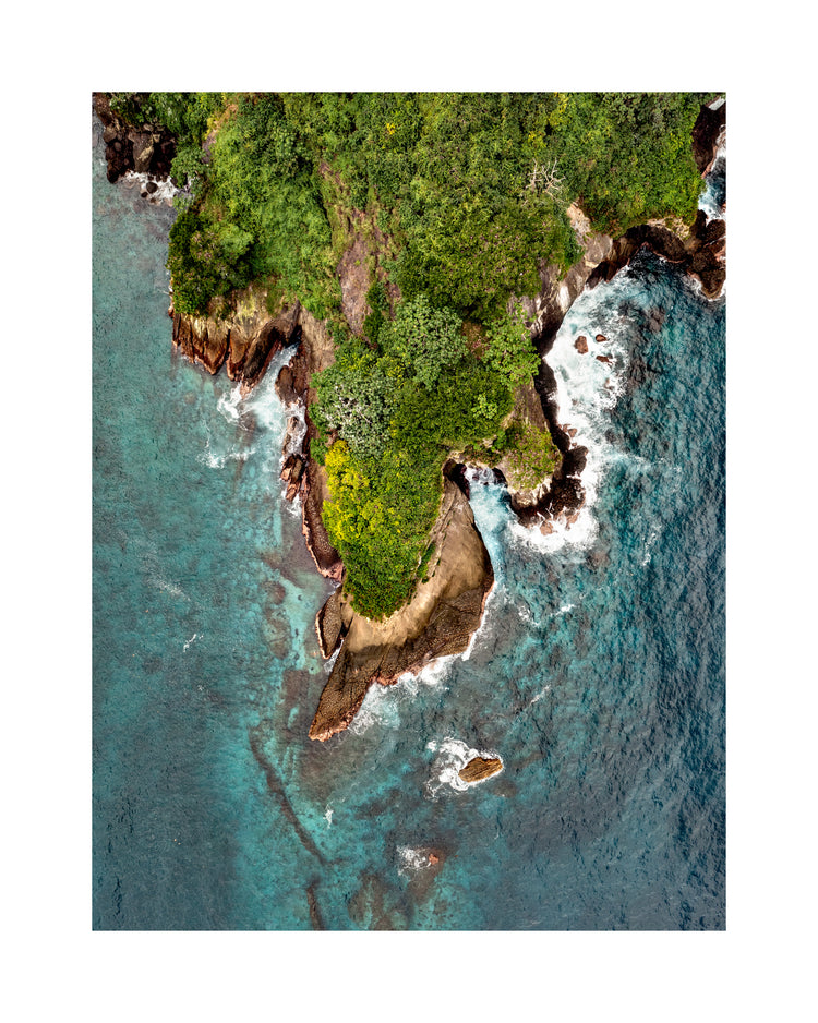 Paradise island covered in tropical jungle and surrounded by turquoise water.