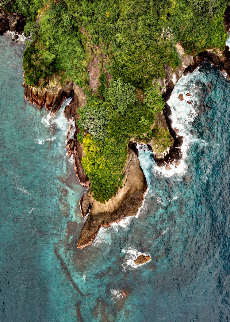 Paradise island covered in tropical jungle and surrounded by turquoise water.