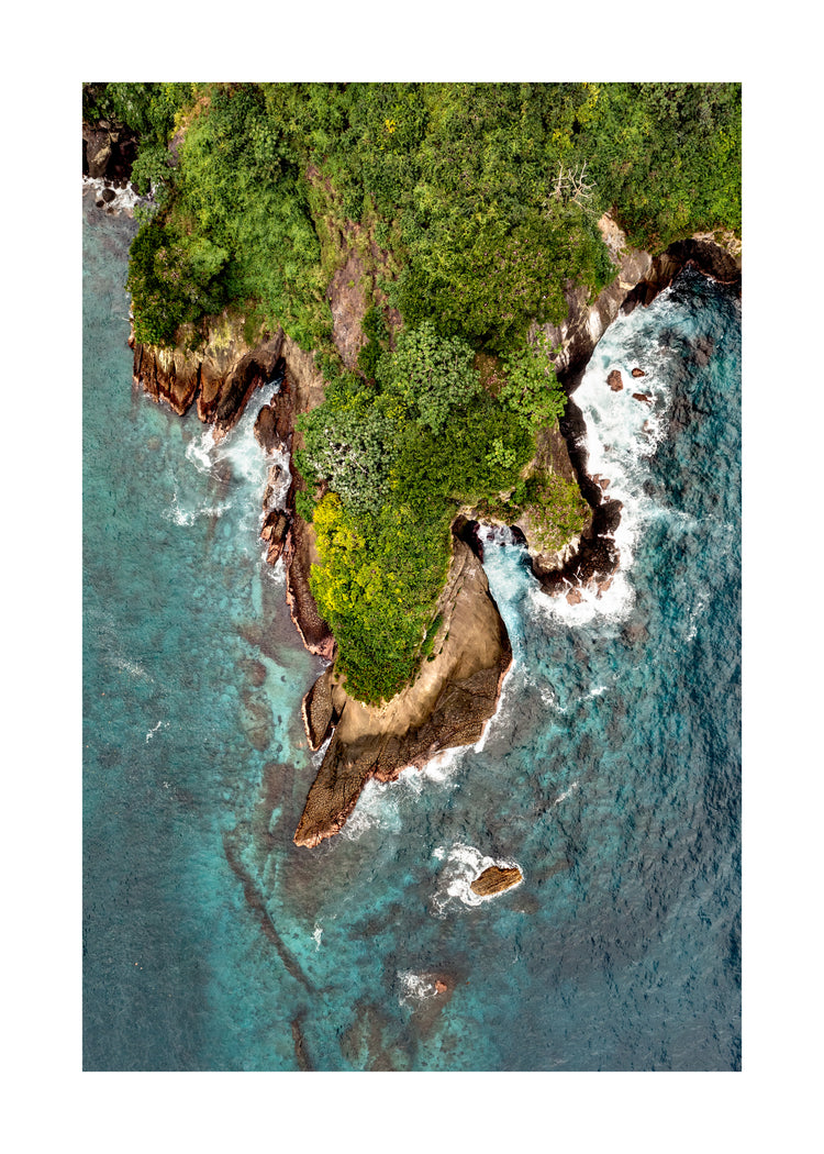 Paradise island covered in tropical jungle and surrounded by turquoise water.