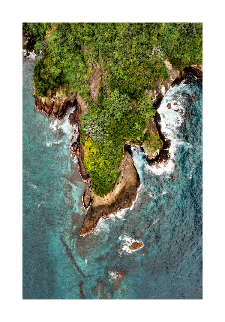 Paradise island covered in tropical jungle and surrounded by turquoise water.