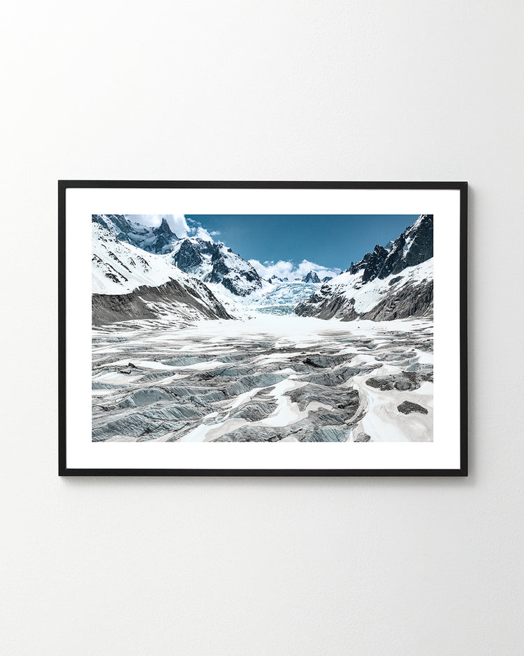 Framed poster titled Greetings From Planet Earth I features a snow-covered mountainous landscape with rugged glaciers and jagged peaks under a clear blue sky, evoking scenes narrated by Sir David Attenborough.