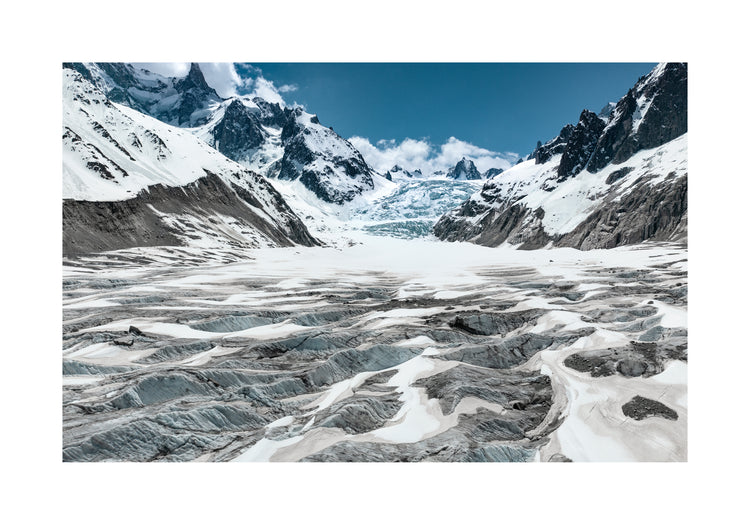Mountain scenery with frozen grounds and snow-capped mountain peaks.