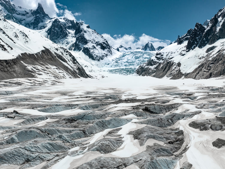 Mountain scenery with frozen grounds and snow-capped mountain peaks.