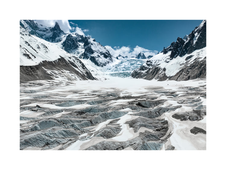 Mountain scenery with frozen grounds and snow-capped mountain peaks.