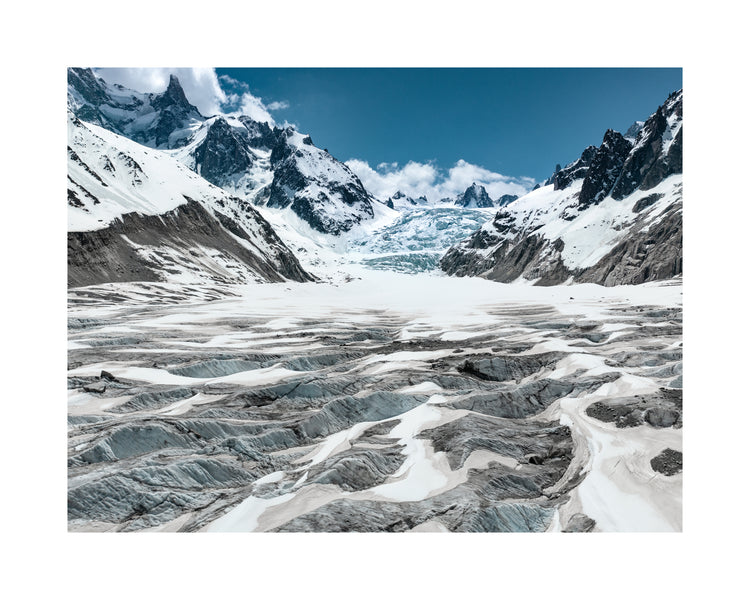 Mountain scenery with frozen grounds and snow-capped mountain peaks.