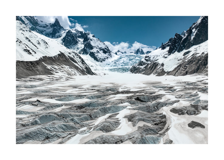Mountain scenery with frozen grounds and snow-capped mountain peaks.