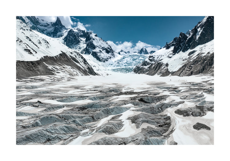 Mountain scenery with frozen grounds and snow-capped mountain peaks.